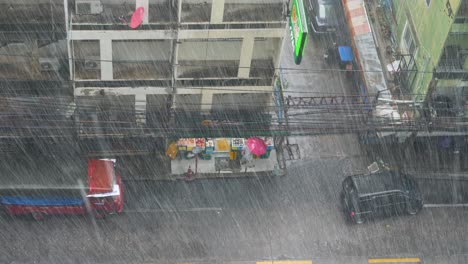 sukhumvit-alley-near-Bang-Chak-Bangkok-during-heavy-rain,-woman-with-red-umbrella,-CP-Freshmarket,-june-2022