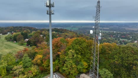 Aerial-rising-shot-of-cell-towers-in-rural-America-during-autumn