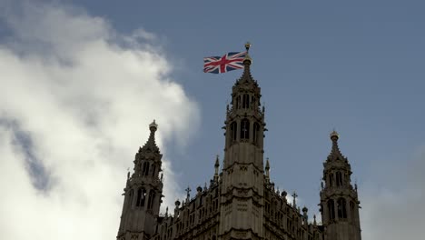 13-January-2023---British-Union-Jack-Flag-Flying-At-Full-Mast-On-Top-Of-Victoria-Tower,-Westminster-Against-Blue-Skies
