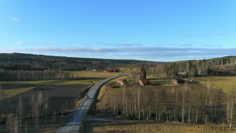 Drone-shot-over-country-road-in-Sweden-in-winter-without-snow