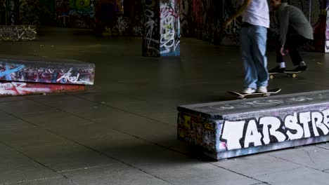 One-skateboarder-does-a-jump-as-people-Skateboarding-in-the-skate-park-Southbank-Center,-London,-UK