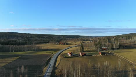 Drone-shot-over-national-road-in-Sweden,-at-winter-without-snow