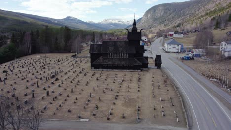 Aerial-view-approaching-a-stave-church-Replica,-spring-day-in-Uvdal,-Norway