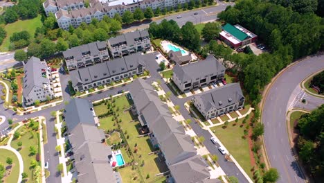 Aerial-drone-shot-of-a-small-neighborhood-in-Alpharetta,-GA-tilting-up-to-look-over-the-larger-portion-of-the-city