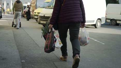 Mujer-Con-Dos-Peticiones-Llenas-De-Frutas-Y-Verduras-Frescas-Del-Mercado-Local-Caminando-De-Regreso-A-Casa-En-Zagreb,-Croacia