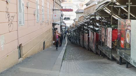People-walking-through-the-small-restaurant-terrace-streets-of-Zagreb