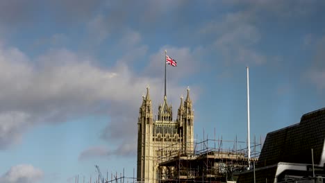 Wide-shot-of-great-Britain-flag-waving-on-top-of-Victoria-Tower---Houses-Of-Parliament-in-London