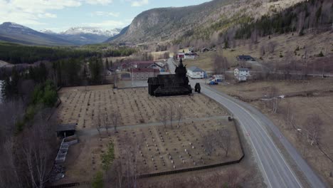 Medieval-wooden-Stave-church-replica,-spring-day-in-Uvdal,-Norway---Aerial-view