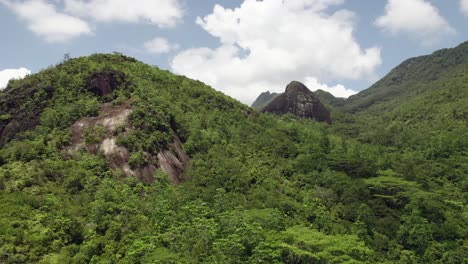 Drone-over-national-park,-anse-major-nature-trail-3,-untouched-national-park-area,-huge-rock-in-the-centre