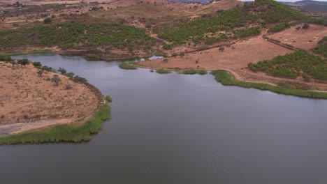 Alentejo-Natural-landscape,-River-and-rural-fields,-Aerial-flyover-shot