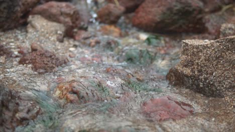 Slow-motion-cinematic,-relaxing-water-stream-on-the-rocks