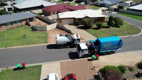 Mulwala,-New-South-Wales,-Australia---10-July-2022:-Street-Sweeper-and-Garbage-Truck-Meet-on-a-Suburban-Street-in-Mulwala-NSW