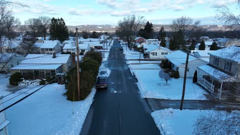 Aerial-dolly-forward-in-snow-covered-neighborhood-outside-of-Williamsport-PA