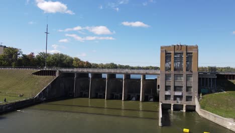 Ypsilanti-hydroelectric-dam-building-complex-and-bridge,-aerial-ascend-view