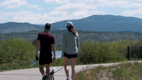 Shot-of-a-couple-walking-a-dog-and-a-cyclist-sharing-a-paved-path-near-Lake-Dillon