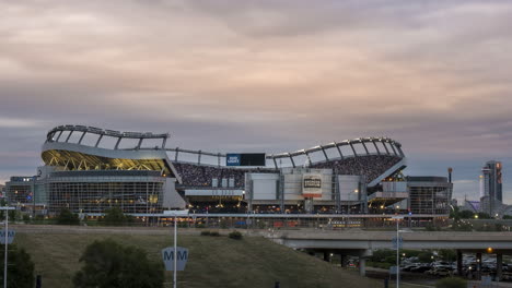 Day-to-night-time-lapse-with-seats-full-of-fans-in-Empower-Field-at-Mile-High-in-Denver,-Colorado
