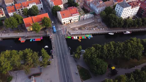 AERIAL-Side-Panning-Shot-of-River-Dane,-Dane-Bridge-in-Klaipeda,-Lithuania