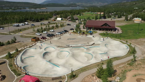 Steigende-Luftaufnahme-Des-Frisco-Skateboardparks-Mit-Dem-Dillon-Reservoir-In-Der-Ferne-In-Colorado