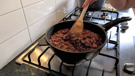 Woman-stirring-chicken-livers-on-a-gas-stove-top-to-make-chicken-liver-pate