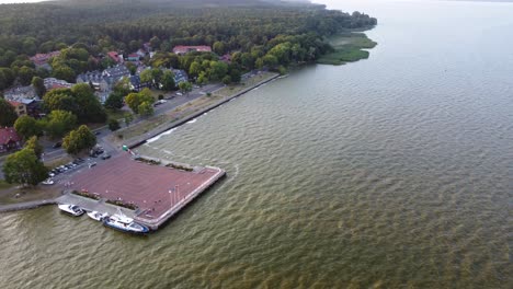 AERIAL-Orbiting-Shot-of-the-Resort-Town-Juodkrante-Coastline-in-Lithuania