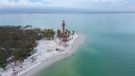 Drone-video-flying-around-the-Sanibel-Lighthouse-historical-landmark-in-Sanibel-Island,-Florida