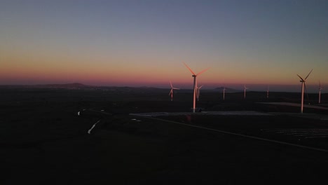 Drone-aerial-view-wind-farm-with-turbines-at-sunset,-Valley-of-Tears,-Israel