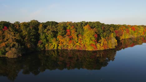 Drone-Across-Lake-in-Michigan-Fall-Colors-Slow-Motion