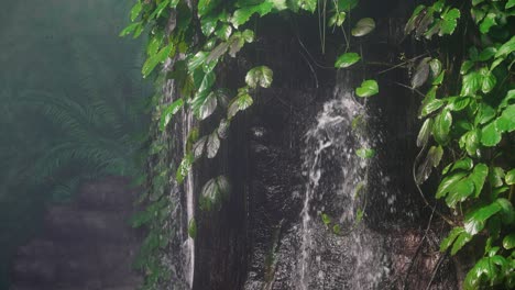 indoor-artificial-waterfall-at-Omaha's-Henry-Doorly-Zoo-with-water-falling-in-a-mistic-way,-dry-and-green-trees