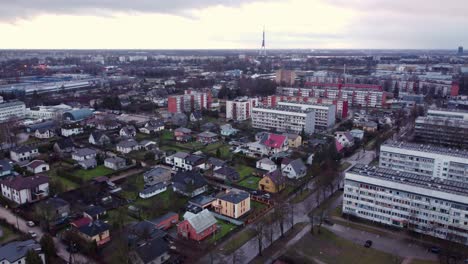 Private-homes-and-massive-apartment-buildings-in-Riga-city,-aerial-view