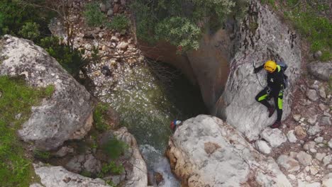 Climbers-rappelling-down-waterfall