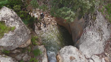 Climber-rappelling-down-waterfall