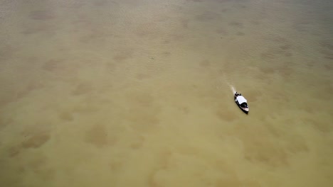 4k-Drone-shot-of-a-boatman-drives-a-boat