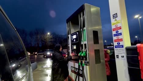 14-January-2023---UK-Muslim-Women-Filling-Up-Petrol-At-Costco-Petrol-Station-In-Watford-In-The-Evening