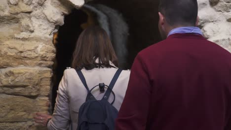 Slowmotion-shot-of-a-married-couple-walking-through-an-underground-tunnel