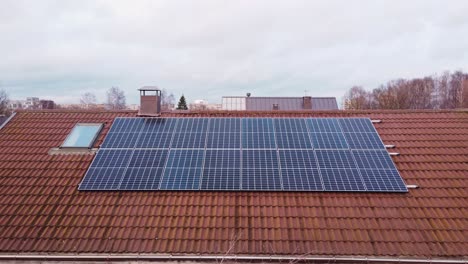 Many-solar-panels-on-private-home-estate-in-Latvia,-aerial-fly-back-view