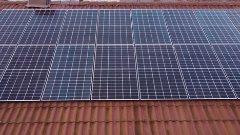 New-installed-Photovoltaic-Solar-Panel-on-top-of-private-house-roof,-aerial
