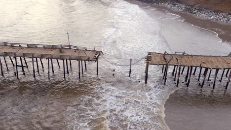 Severe-damage-to-the-Capitola-Wharf-pier-after-storms-in-California,-January-2023---aerial-orbit