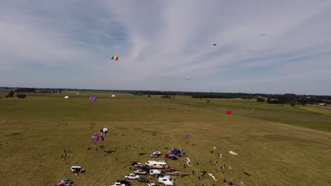 Aerial-view-of-many-kites-flying-at-sky-during-windy-day-in-Buenos-Aires-during-aeromodelling-event---wide-shot