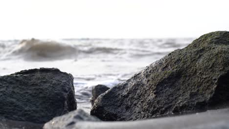 close-up-of-rock-crevice-with-ocean-waves-in-the-background
