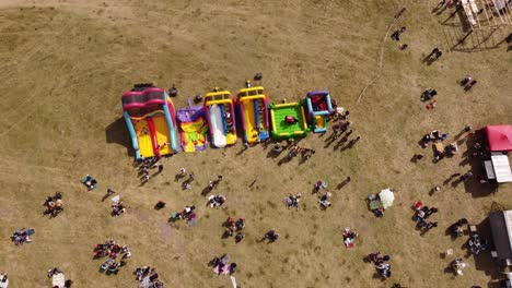Ascending-top-down-shot-colored-inflatable-games-for-kids-outdoors-in-sunlight