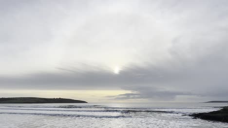 Wide-panorama-of-sun-halo-over-winter-sky-and-ocean-waves-in-Ireland