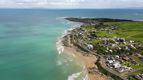 An-aerial-shot-over-a-calming-coastline-of-Riverton,-New-Zealand