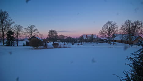 Colorful-dawn-over-small-rural-village-landscape-in-winter-season,-fusion-time-lapse