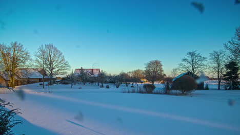 Day-to-night-timelapse-of-rural-snowy-landscape-and-moon-rising-up-in-sky