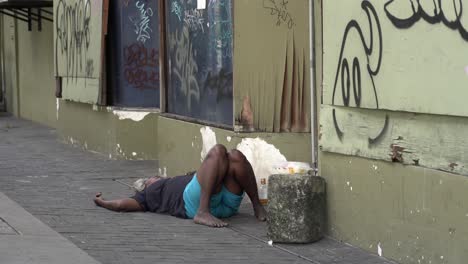 Alcoholic-Man-Laying-Passed-Out-on-Sidewalk-at-Kuala-Lumpur-street,-Malaysia