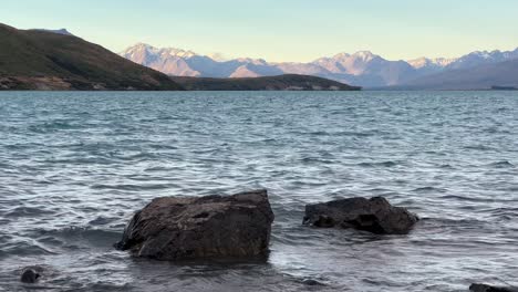 Two-rocks-at-the-shore-of-Lake-Tekapo-on-tranquil-evening