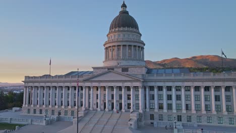 Close-up-drone-panning-shot-of-Utah-State-Capitol-building-as-the-sun-sets-over-Salt-Lake-City