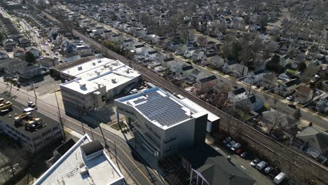 An-aerial-view-of-an-office-building-with-solar-panels-on-the-roof-on-a-sunny-day