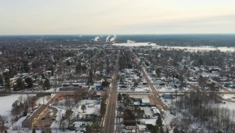 Aerial,-empty-main-street-of-a-small-rural-suburban-town-in-the-United-States-during-winter