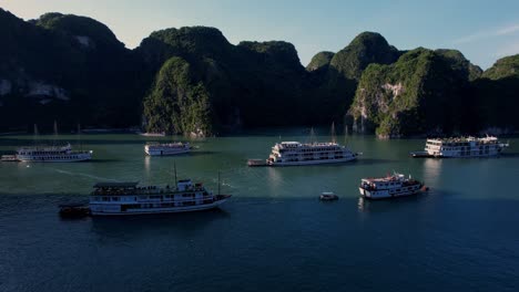 Aerial-Halong-Bay-junk-boats-surrounded-by-rock-formations,-Vietnam